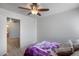 Cozy bedroom featuring a ceiling fan, wood floors and view of the bathroom at 1673 S 218Th Ave, Buckeye, AZ 85326