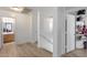 Bright hallway with wood floors leading to the bathroom and bedrooms at 1673 S 218Th Ave, Buckeye, AZ 85326
