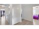 Hallway with wood floors leading to the bedroom with a ceiling fan at 1673 S 218Th Ave, Buckeye, AZ 85326