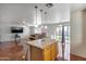 Open-concept kitchen and living room with tile flooring and a breakfast bar featuring seating at 1673 S 218Th Ave, Buckeye, AZ 85326