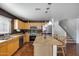 Kitchen featuring stainless steel appliances, an island with seating, and tile backsplash at 1673 S 218Th Ave, Buckeye, AZ 85326