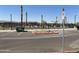 Image of the community pool area with lounge chairs, palm trees, and a parking lot at 17068 W Shangri La Rd, Surprise, AZ 85388