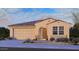 Charming single-story home featuring a terracotta roof, a two-car garage, and desert landscaping at 17068 W Shangri La Rd, Surprise, AZ 85388