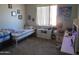 Bright bedroom with a twin bed, desk, and carpeted floors, perfect for study and rest at 1941 S Pierpont Dr # 2082, Mesa, AZ 85206