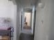 Bright hallway with several doors leading to other rooms and a small table at 1941 S Pierpont Dr # 2082, Mesa, AZ 85206
