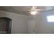 Bright, open living room with neutral walls, a ceiling fan, and ample natural light, perfect for relaxation at 1941 S Pierpont Dr # 2082, Mesa, AZ 85206