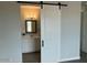 Stylish bathroom with a sliding door, bright vanity, and well-lit mirror for a modern touch at 22113 W Laura St, Wittmann, AZ 85361