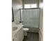 Well-lit bathroom featuring a tub with glass doors, vanity and sink combo, and modern fixtures at 22113 W Laura St, Wittmann, AZ 85361