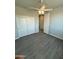 Bedroom with wood-look flooring, ceiling fan and closet at 22113 W Laura St, Wittmann, AZ 85361