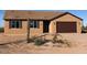 Lovely single-story home with attached two-car garage and desert landscaping at 22113 W Laura St, Wittmann, AZ 85361