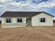 Stylish single-story home boasting white siding, decorative shutters, and gray stone accents at 22113 W Laura St, Wittmann, AZ 85361