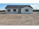Modern single-story home with gray stone accents, matching shutters, and spacious front yard at 22113 W Laura St, Wittmann, AZ 85361