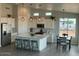 Bright kitchen with white cabinetry, stainless steel appliances, an island, and a cozy dining area at 22113 W Laura St, Wittmann, AZ 85361