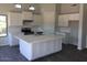 Modern kitchen featuring a large island, white cabinetry, and stainless steel appliances at 22113 W Laura St, Wittmann, AZ 85361