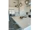 Close-up of the kitchen island features a quartz countertop with seating and a stainless steel sink at 22113 W Laura St, Wittmann, AZ 85361