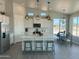 Bright kitchen featuring a quartz island, pendant lights, and stainless steel appliances at 22113 W Laura St, Wittmann, AZ 85361