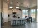 Contemporary kitchen featuring white cabinets, a center island with seating, and stainless steel appliances at 22113 W Laura St, Wittmann, AZ 85361
