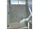 Modern shower featuring marble-style tiling, a glass door, and a built-in bench at 22113 W Laura St, Wittmann, AZ 85361