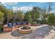 Outdoor seating area with built-in bench, pillows, and fire pit at 22402 N 84Th Pl, Scottsdale, AZ 85255