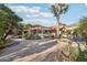 Luxury backyard with fire pit, fountains, mature palms, and red tiled roofline at 22402 N 84Th Pl, Scottsdale, AZ 85255