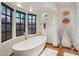Bathroom featuring soaking tub with a bay window and Spanish tile flooring at 22402 N 84Th Pl, Scottsdale, AZ 85255