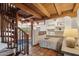 Cozy bedroom with a spiral staircase, wooden beams, terracotta floors, and built-in shelving at 22402 N 84Th Pl, Scottsdale, AZ 85255