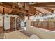 Bedroom featuring high ceilings, wooden beams, spiral staircase, and fireplace with cozy neutral decor at 22402 N 84Th Pl, Scottsdale, AZ 85255