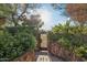 Landscaped pathway leading to an ornate gated entrance, enhancing privacy and charm at 22402 N 84Th Pl, Scottsdale, AZ 85255