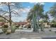 Stunning home with lush desert landscaping, mature trees, and a well-maintained yard at 22402 N 84Th Pl, Scottsdale, AZ 85255