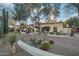 Beautiful home with lush desert landscaping, mature trees, and a well-maintained yard at 22402 N 84Th Pl, Scottsdale, AZ 85255