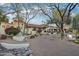 Beautiful desert landscaping surrounds this single-story home with brick-paved drive and mature shade trees at 22402 N 84Th Pl, Scottsdale, AZ 85255