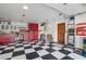 Organized garage with checkerboard floors, red cabinets, and plenty of storage space at 22402 N 84Th Pl, Scottsdale, AZ 85255