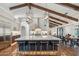 Bright kitchen with an oversized kitchen island, bar stool seating, and custom lighting at 22402 N 84Th Pl, Scottsdale, AZ 85255