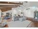 Open living room boasts exposed wood beams, terra cotta floors, and a comfortable gray sectional sofa at 22402 N 84Th Pl, Scottsdale, AZ 85255
