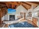 Charming living room featuring a fireplace, wood ceiling beams, tile floors, and ample natural light at 22402 N 84Th Pl, Scottsdale, AZ 85255