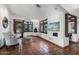 Bright living room featuring terracotta floors, a fireplace, large windows, and comfortable seating at 22402 N 84Th Pl, Scottsdale, AZ 85255