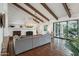 Bright living room with high ceilings, exposed beams, a fireplace, and access to the outdoors at 22402 N 84Th Pl, Scottsdale, AZ 85255