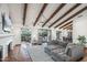 Bright living room featuring wood beam ceilings, Spanish tile flooring, and a large sectional sofa at 22402 N 84Th Pl, Scottsdale, AZ 85255