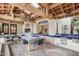 Outdoor kitchen area with skylights, stone flooring, wooden beams, chandelier, and a seating area at 22402 N 84Th Pl, Scottsdale, AZ 85255