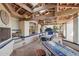 Outdoor dining area with an open kitchen, stone floor, wooden beams, and view of the landscaped backyard at 22402 N 84Th Pl, Scottsdale, AZ 85255