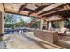 Spacious outdoor living area with a pool view, fireplace, and comfortable seating, ideal for entertaining at 22402 N 84Th Pl, Scottsdale, AZ 85255