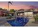 Stunning backyard with a sparkling pool, lush landscaping, and a covered patio area, perfect for relaxation at 22402 N 84Th Pl, Scottsdale, AZ 85255