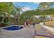 Secluded backyard pool area with stone patio, lush landscaping, and a built-in spa at 22402 N 84Th Pl, Scottsdale, AZ 85255