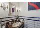 Elegant powder room featuring a vessel sink, decorative mirror, custom tile work, and stylish lighting at 22402 N 84Th Pl, Scottsdale, AZ 85255