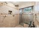 Tiled shower with glass door and custom fixtures at 22402 N 84Th Pl, Scottsdale, AZ 85255