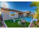 Well-manicured backyard featuring a pool, turf, and outdoor furniture at 27629 N 176Th Dr, Surprise, AZ 85387