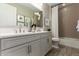 Stylish bathroom featuring double sinks, granite countertop, and tiled shower/tub at 27629 N 176Th Dr, Surprise, AZ 85387