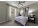 Comfortable bedroom with carpet, ceiling fan, and bright window light at 27629 N 176Th Dr, Surprise, AZ 85387