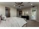 The bedroom includes a door to the patio and a dark wood dresser with a decorative mirror at 27629 N 176Th Dr, Surprise, AZ 85387