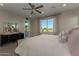 Bedroom overlooking the pool area with a dark wood dresser and upholstered bed frame at 27629 N 176Th Dr, Surprise, AZ 85387